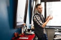 Barber invites to have seat on chair at barbershop