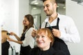 Barber makes the cut for woman Royalty Free Stock Photo