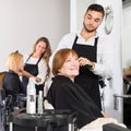 Barber makes the cut for woman Royalty Free Stock Photo