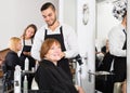 Barber makes the cut for woman Royalty Free Stock Photo