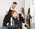 Barber makes the cut for woman Royalty Free Stock Photo