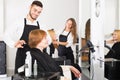 Barber makes the cut for woman Royalty Free Stock Photo