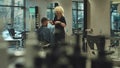 Barber makes haircut with scissors to man, prioritising beauty and hair health