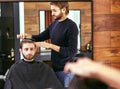 Barber makes men haircut at the beauty salon Royalty Free Stock Photo