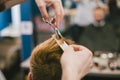 Barber Making Haircut Bearded Man In Barbershop. Professional stylist cutting client hair in salon. Barber using Royalty Free Stock Photo