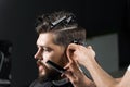 Barber making hairstyle for confident bearded hipster. Advertising for barbershop and men& x27;s beauty salon.