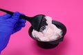 barber mixes the hair dye with a brush in a bowl Royalty Free Stock Photo