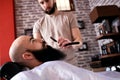 Barber with old-fashioned black razor Royalty Free Stock Photo