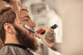 Barber with old-fashioned black razor Royalty Free Stock Photo