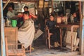 Barber for the poor in the poor quarter of Kathmandu. Street barber shop