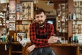 Barber with razor poses at the chair, barbershop