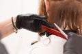 Closeup of barber cutting customer`s hair with scissors and comb Royalty Free Stock Photo