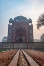 barber\'s tomb entrance gate at misty morning from unique perspective