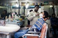 Barber shaving man in Delhi