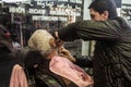 Barber shaving one of his client at night, in an old fashionned barber shop on the European side of the city