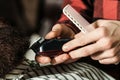 Barber shearing beard to man, close up. Male hairstylist serving client. Bearded man. Barber shop Royalty Free Stock Photo