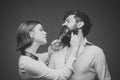 Barber shop. Hair style. Barbershop or hairdresser concept. Woman hairdresser cuts beard with scissors. Man with long Royalty Free Stock Photo