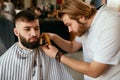 Barber Shop. Man Gets Beard Hair Cut