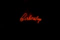 Barber Shop Neon Light Sign. Business. Red letters over black ba