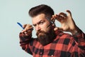 Barber shop. Stylish barber with professional tools. Brutal hipster with beard, moustache. Business concept. Bearded style,