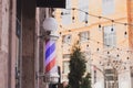 Barber sign and male hairdresser pole or staff mounted on wall. Helix of colored stripes red white and blue Royalty Free Stock Photo