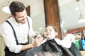 Barber Smiling While Preparing Boy To Shave