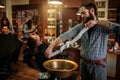 Barber squeeze towel in copper basin at barbershop