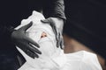 Barber steam face skin of man with hot towel before royal shave in Barbershop