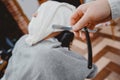 Barber steam face skin of man with hot towel before royal shave in Barbershop