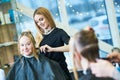 Barber or stylist at work. Hairdresser cutting woman hair Royalty Free Stock Photo