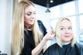 Barber or stylist at work. Hairdresser cutting woman hair Royalty Free Stock Photo