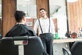 Barber Talking To Customer While Asking About His Preferences