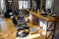 Barber tools on wooden shelf and mirror in barbershop