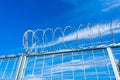 Barbered wire over a blue sky and on building ground, rusty Royalty Free Stock Photo