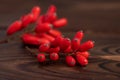 Barberry, Berberis vulgaris, branch with natural fresh ripe red berries on wooden background Royalty Free Stock Photo