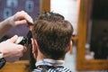 Barbers hands making haircut to man using trimmer Royalty Free Stock Photo