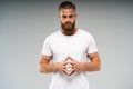 Barbershop advertising. Close up portrait of severe hot red bearded guy with stylish hairdo. He is standing with crossed Royalty Free Stock Photo