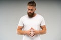 Barbershop advertising. Close up portrait of severe hot red bearded guy with stylish hairdo. He is standing with crossed Royalty Free Stock Photo