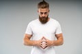 Barbershop advertising. Close up portrait of severe hot red bearded guy with stylish hairdo. He is standing with crossed Royalty Free Stock Photo