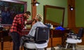 Barbershop client. Trimming beard. Barbershop services. As gentleman and decent human being, you must tip your barber