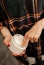 Barbershop, closeup: a barber applying shaving gel to beard