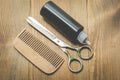 Barbershop concept. Hairbrushes, sprayer and a scissors on a wooden board, top view Royalty Free Stock Photo