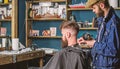 Barbershop concept. Hipster bearded client got hairstyle. Barber with hairdryer works on hairstyle for bearded man Royalty Free Stock Photo