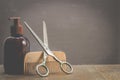 Barbershop concept. Old style. Hairbrushes, sprayer and a scissors on a gray background with copy space. Selective focus Royalty Free Stock Photo