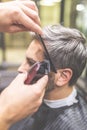 Barbershop. Hairdresser does hairstyle with hair clipper and comb Royalty Free Stock Photo