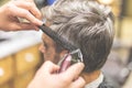 Barbershop. Hairdresser does hairstyle with hair clipper and comb Royalty Free Stock Photo