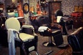 Barbershop interior. Reflections. Chairs. Colorful. Old. Retro. Colors white blue black brown white yellow. Style. Design.