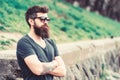 Barbershop and style concept. Man with beard and mustache on strict face, nature background, defocused. Hipster with Royalty Free Stock Photo