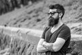 Barbershop and style concept. Man with beard and mustache on strict face, nature background, defocused. Hipster with Royalty Free Stock Photo