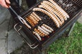 Barbiquing sausages on hot grill. Top view.